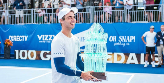 Image of pro pickleball player Ben Johns holding a trophy during a PPA Tour stop.
