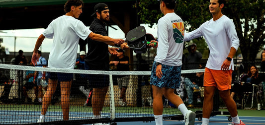 Players tap paddles after a pickleball game.