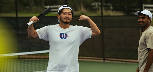 A pickleball player celebrates after winning a point.