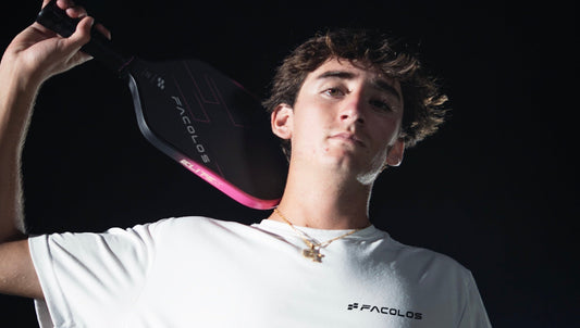 Gabe Tardio holds a Facolos pickleball paddle.