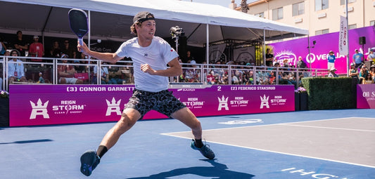 Pro pickleball player Connor Garnett mid-point at a PPA Tour event