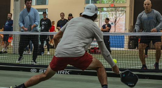 Pickleball player reaches for a dink