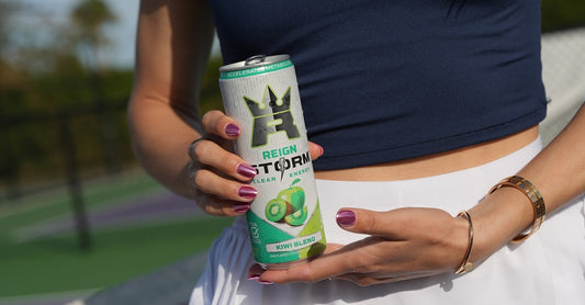 A can of Reign Storm energy drink held by a pickleball player